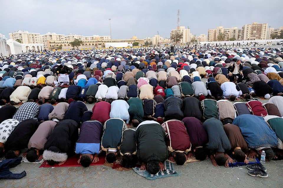 People attend an Eid al-Fitr prayer, marking the end of the Muslim holy fasting month of Ramadan at a public square, in Benghazi, Libya on 21 April, 2023.
