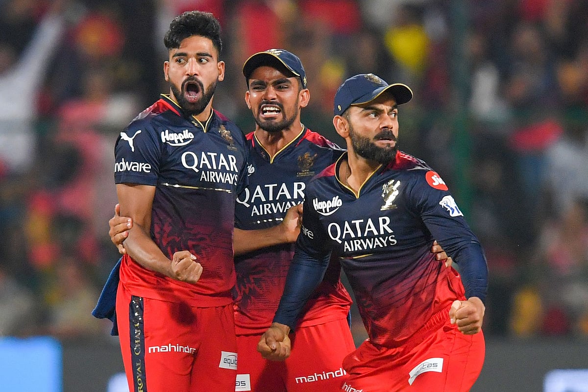 Royal Challengers Bangalore's Virat Kohli celebrates with teammates after the dismissal of Chennai Super Kings' Ruturaj Gaikwad during the Indian Premier League match between Royal Challengers Bangalore and Chennai Super Kings at the M Chinnaswamy Stadium in Bengaluru on 17 April 2023