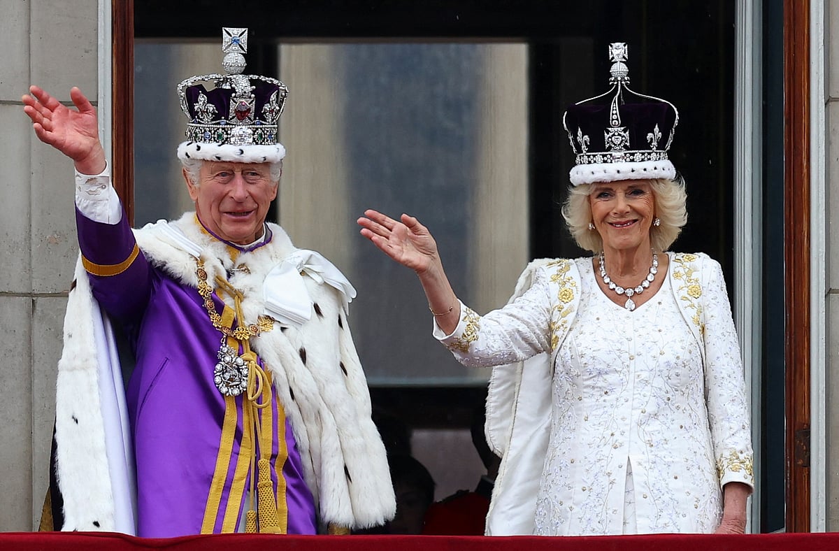 Britain's King Charles and Queen Camilla gesture as they stand on the Buckingham Palace balcony following their coronation ceremony in London, Britain 6 May, 2023.