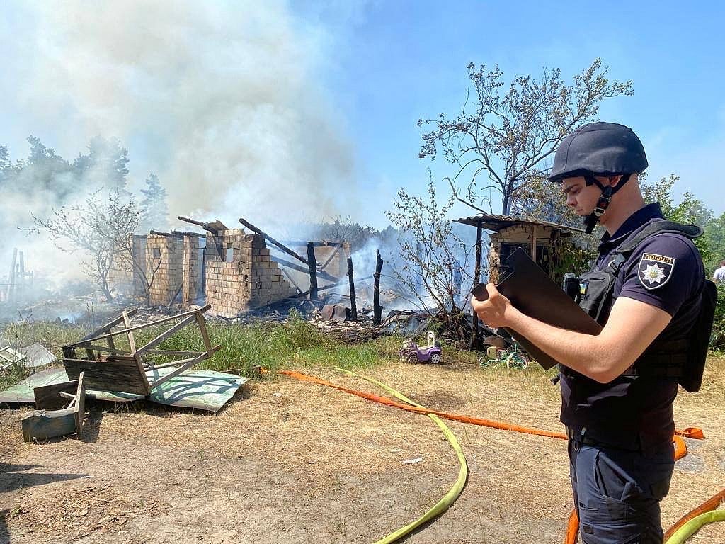 A police officer inspects damages after Russian missiles strike, amid Russia's attack on Ukraine, in Kyiv region, Ukraine May 29, 2023