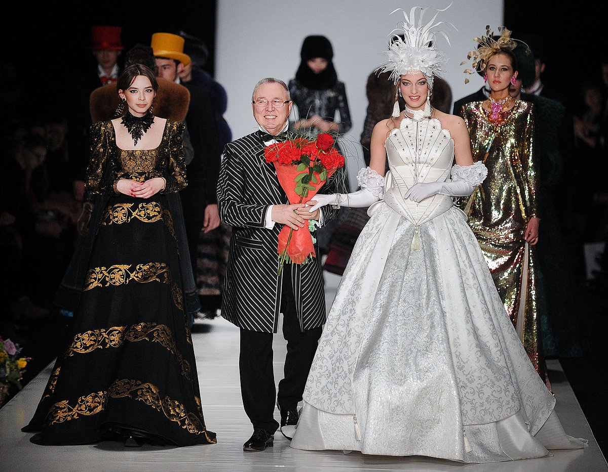 In this file photo taken on 29 March, 2013 Russian fashion designer Slava Zaitsev (C) walks on stage surrounded by models during the Fashion Week in Moscow. Russian couturier Viacheslav "Slava" Zaitsev has died at the age of 85, a spokeswoman for his fashion house in Moscow told AFP.