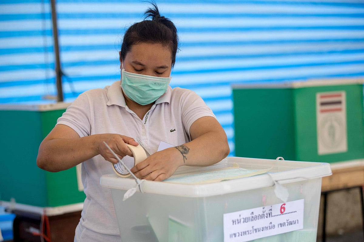 An electoral official seals a ballot box at a polling station in Bangkok on 14 May, 2023 after polls closed in Thailand's general election