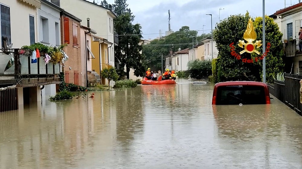 Rescuers take people to safety during rescue operations, in Forli, Italy after floods hit Italy's northern Emilia-Romagna region, in this handout image released on 17 May, 2023.