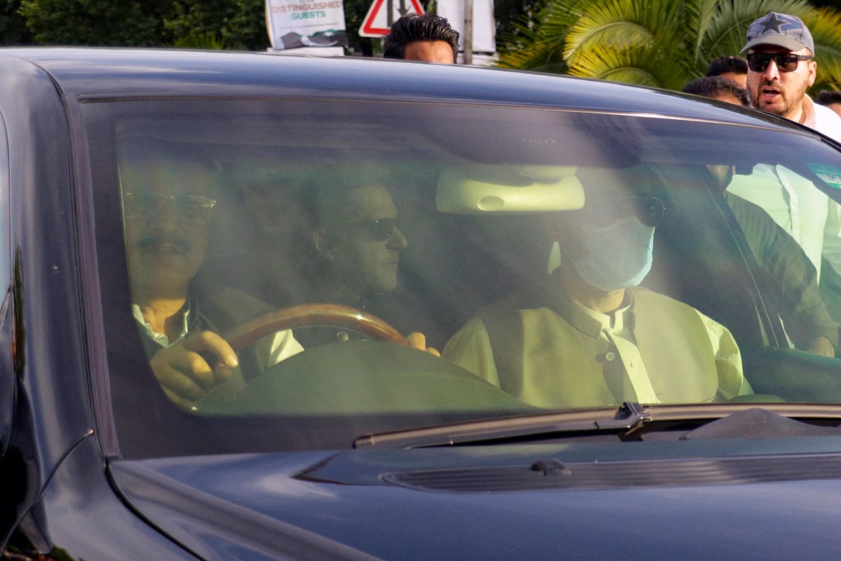 A car carries Pakistan's former Prime Minister Imran Khan, as he arrives to appear before the Supreme Court in Islamabad on 11 May, 2023