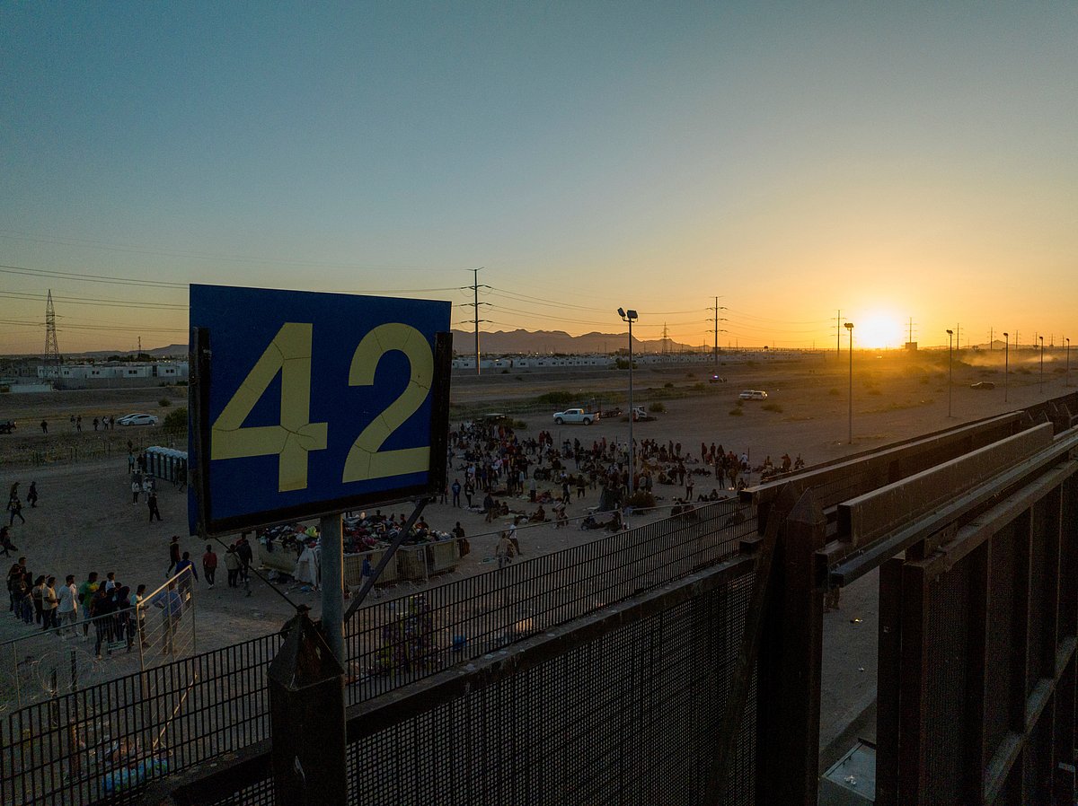 Migrants stand near Border Gate 42 along the border highway, as the U.S. prepares to lift COVID-19 era Title 42 restrictions that have blocked migrants at the border from seeking asylum since 2020, in El Paso, Texas, US, on 11 May
, 2023
