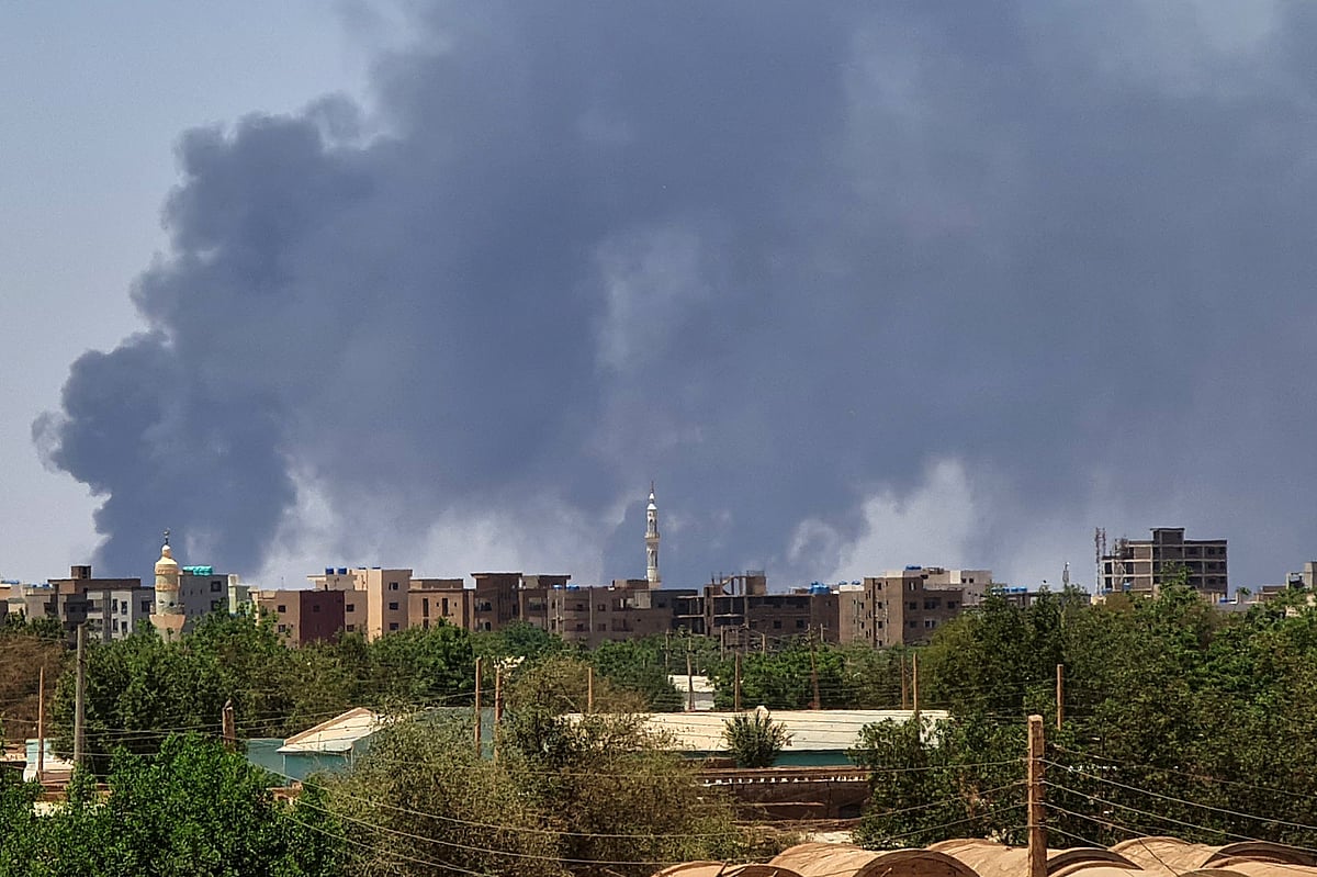 Smoke billows over buildings in Khartoum on 1 May 2023 as deadly clashes between rival generals' forces have entered their third week.