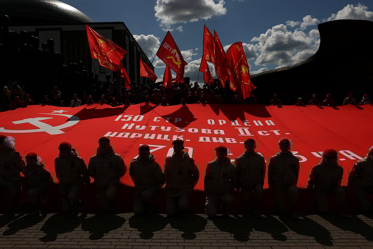 Members of the Youth Army movement hold a large copy of the Soviet Banner of Victory during a gathering of members and supporters of the Russian Communist Party on the eve of Victory Day, marking the anniversary of the victory over Nazi Germany in World War Two, in Moscow, Russia May 8, 2023