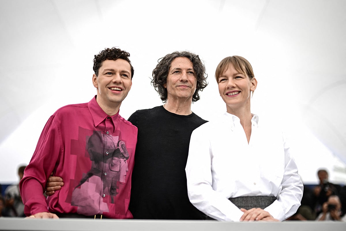 (From L) German actor Christian Friedel, British director Jonathan Glazer and German actress Sandra Hueller pose during a photocall for the film "The Zone Of Interest" at the 76th edition of the Cannes Film Festival in Cannes, southern France, on 20 May, 2023.