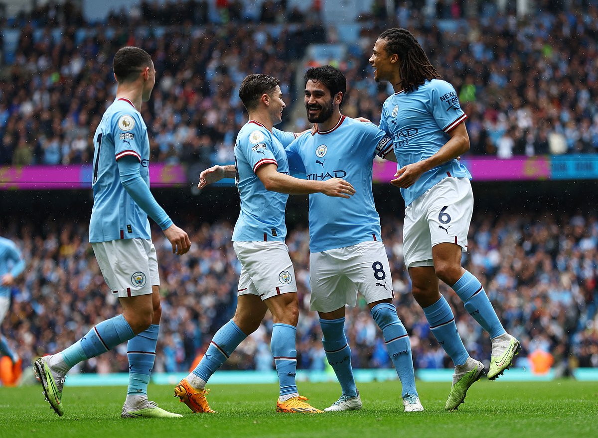 Manchester City's Ilkay Gundogan celebrates scoring their second goal with Julian Alvarez and Nathan Ake in their English Premier League match against Leeds United at the Etihad Stadium in Manchester, Britain on 6 May 2023