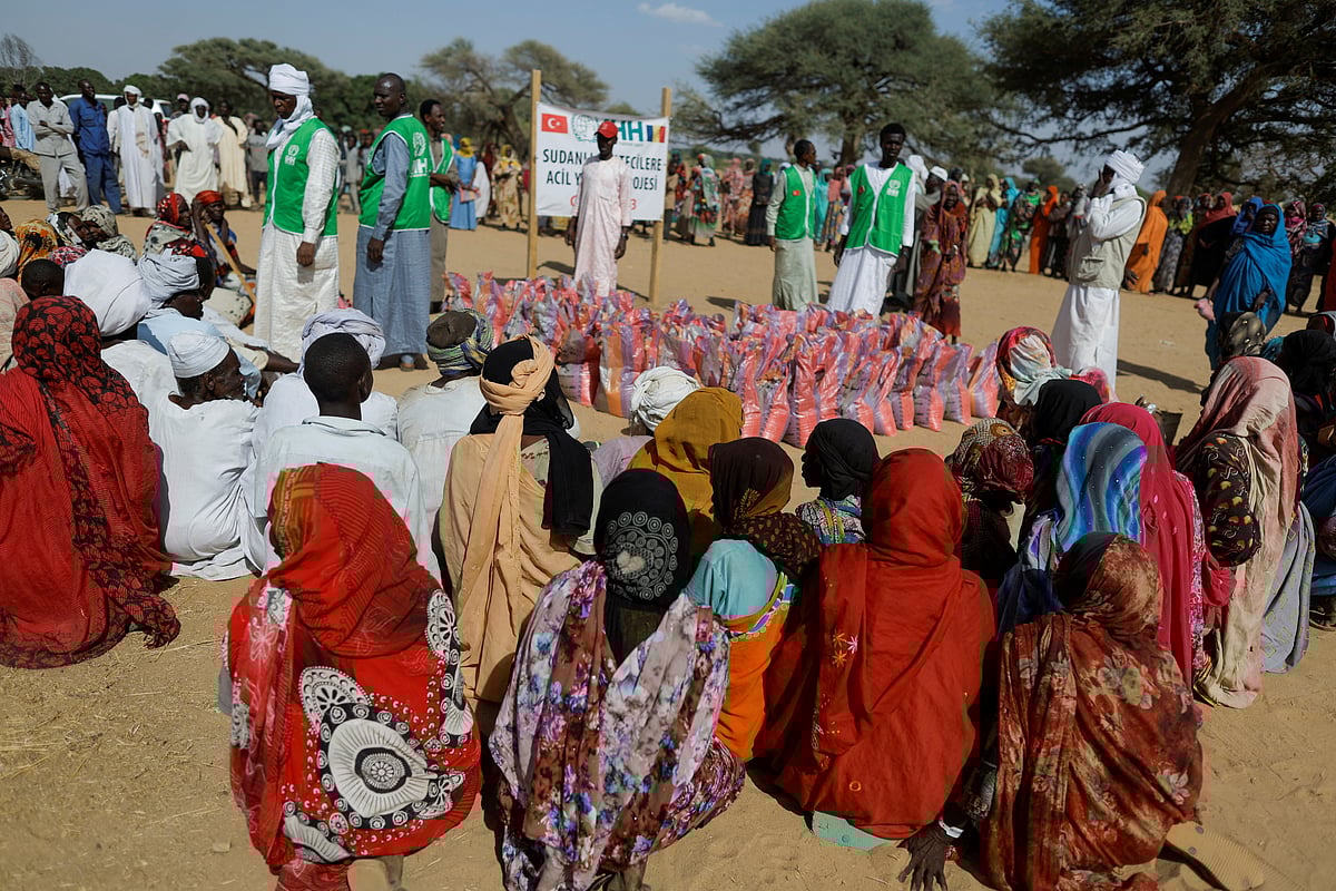 Sudanese refugees, who fled the violence in their country, wait to receive food supplies from a Turkish aid group (IHH) near the border between Sudan and Chad in Koufroun, Chad May 7, 2023