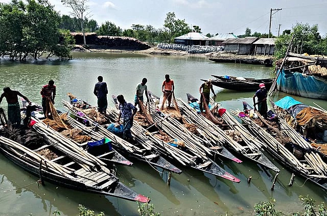 Fishermen returning to shore after the water level rises in the rivers in Sunderbans. This picture captured near the Sutiya Bazar launch terminal in Koyra
