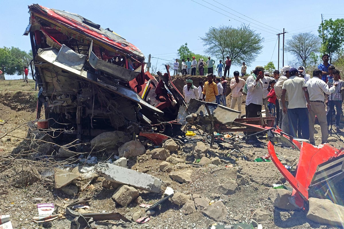 Onlookers gather at the site of a bus accident in Khargone district of India’s Madhya Pradesh state on 9 May, 2023