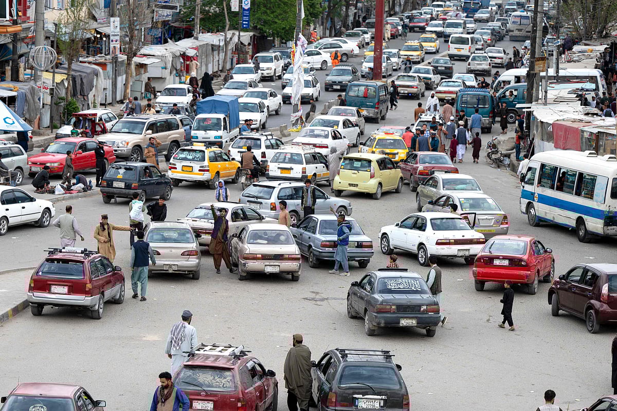 This photograph taken on April 25, 2023, shows Toyota Corolla cars in a traffic jam beneath the kot-e Sangi bridge in Kabul. Little is certain in Afghanistan -- armies invade and retreat, governments rise and fall -- but when the key of a Toyota Corolla turns in the ignition, the engine can be relied upon to roar to life