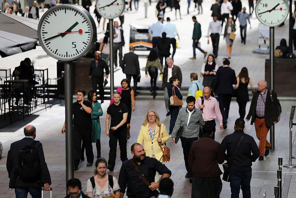 People walk through the financial district of Canary Wharf, London, Britain on 28 September 2017.