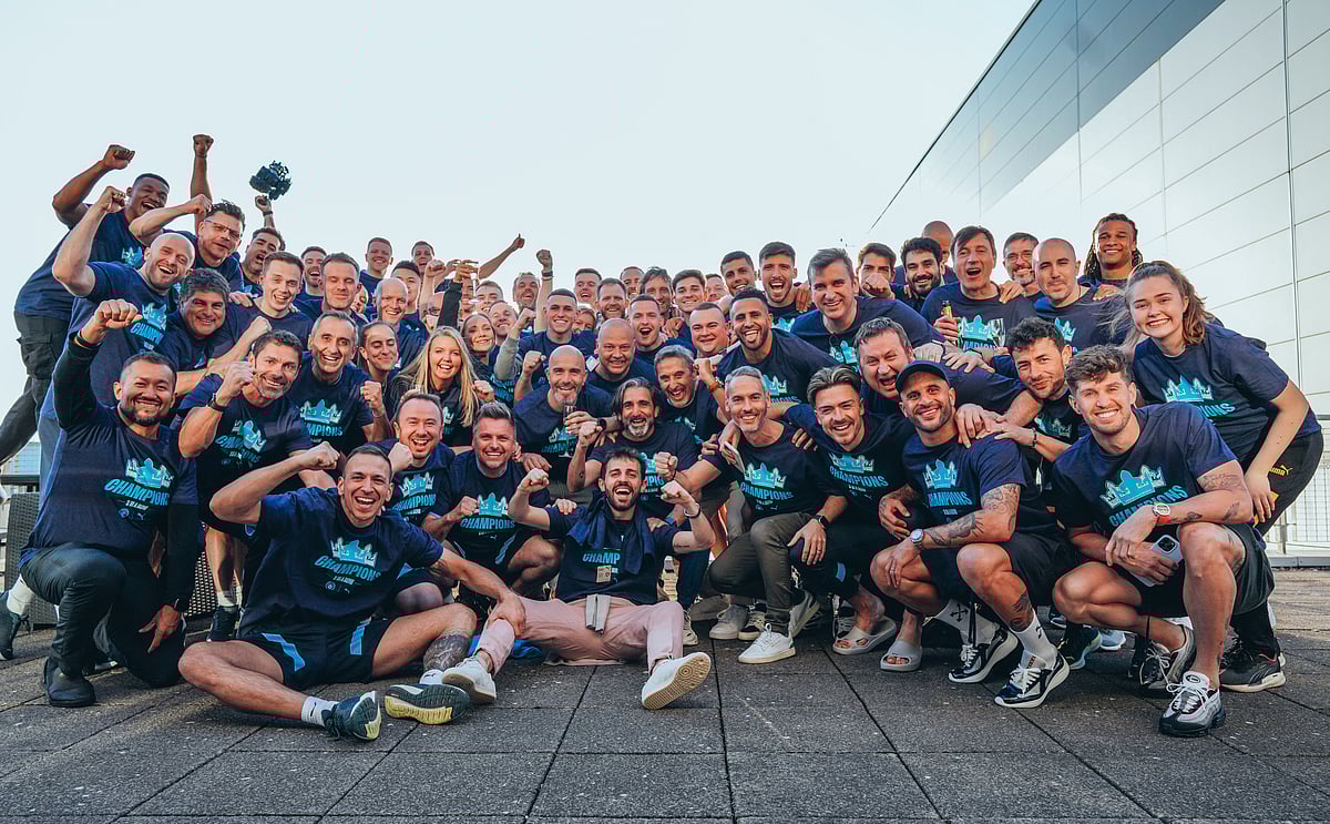 Manchester City squad celebrates after winning the English Premier League title on 21 May 2023