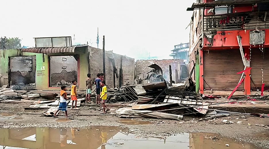 Wrecked remains of houses and shops seen following fresh violence that occurred in several areas of Manipur, on 12 June 2023