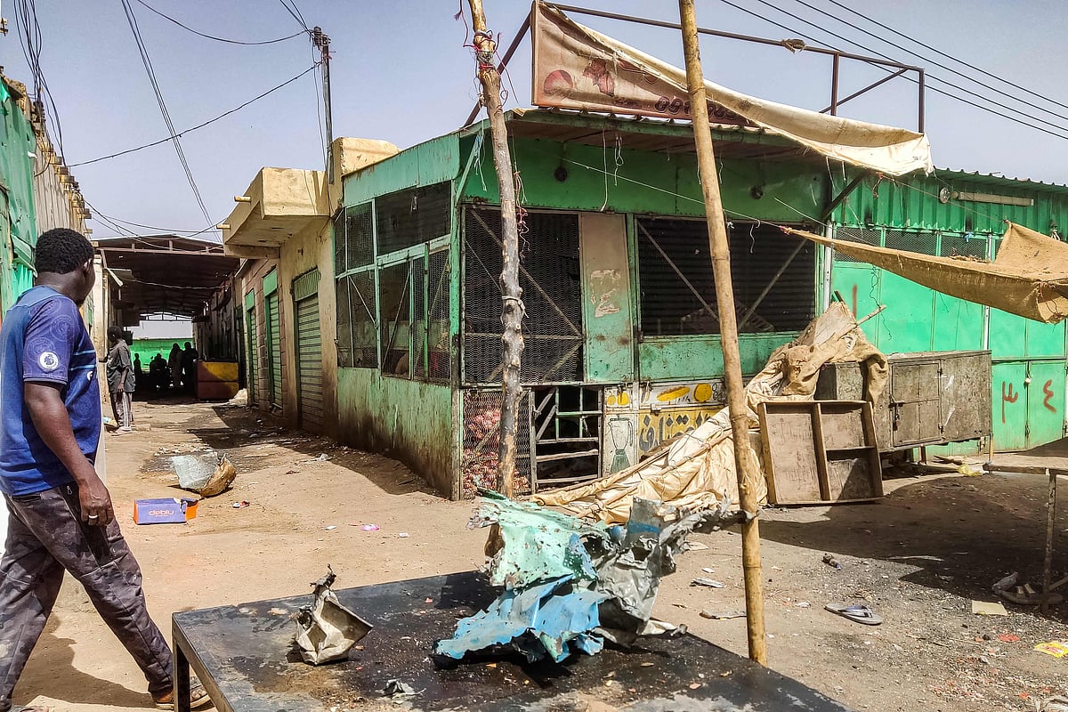 A man walks past damaged stalls at the Souk Sitta (Market Six) in the south of Khartoum on June 1, 2023.