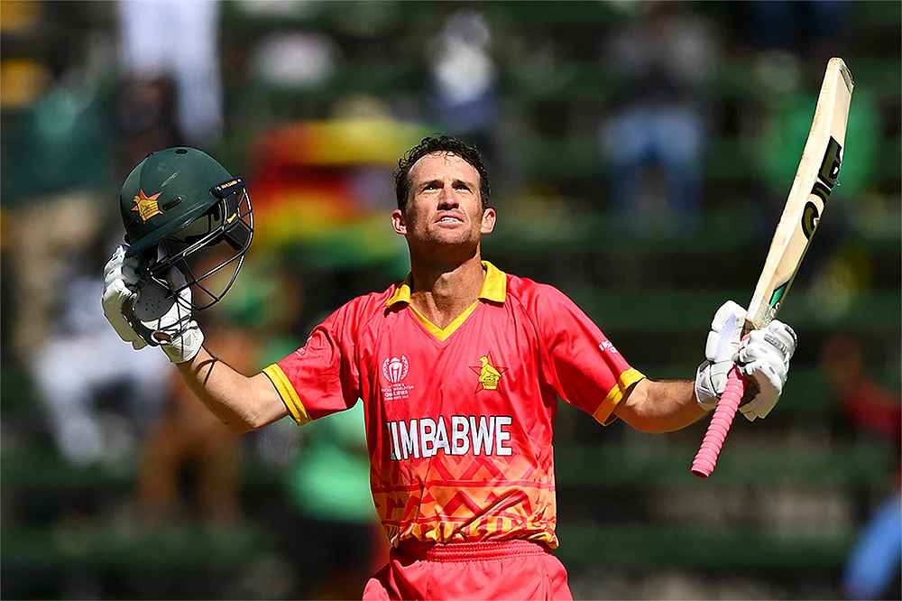 Zimbabwe's Sean Williams celebrates after reaching his hundred in the ICC World Cup Qualifier match against the US in Harare, Zimbabwe on 26 June 2023