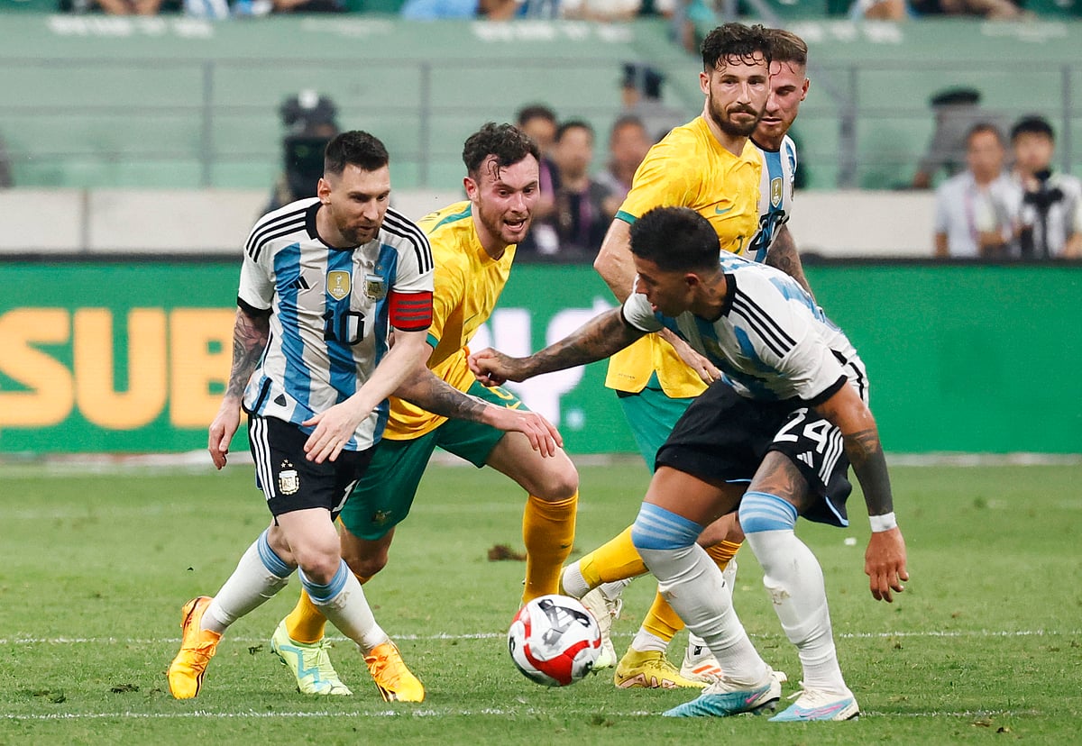 Argentina's Lionel Messi and Enzo Fernandez in action with Australia's Aiden O'Neill and Mathew Leckie