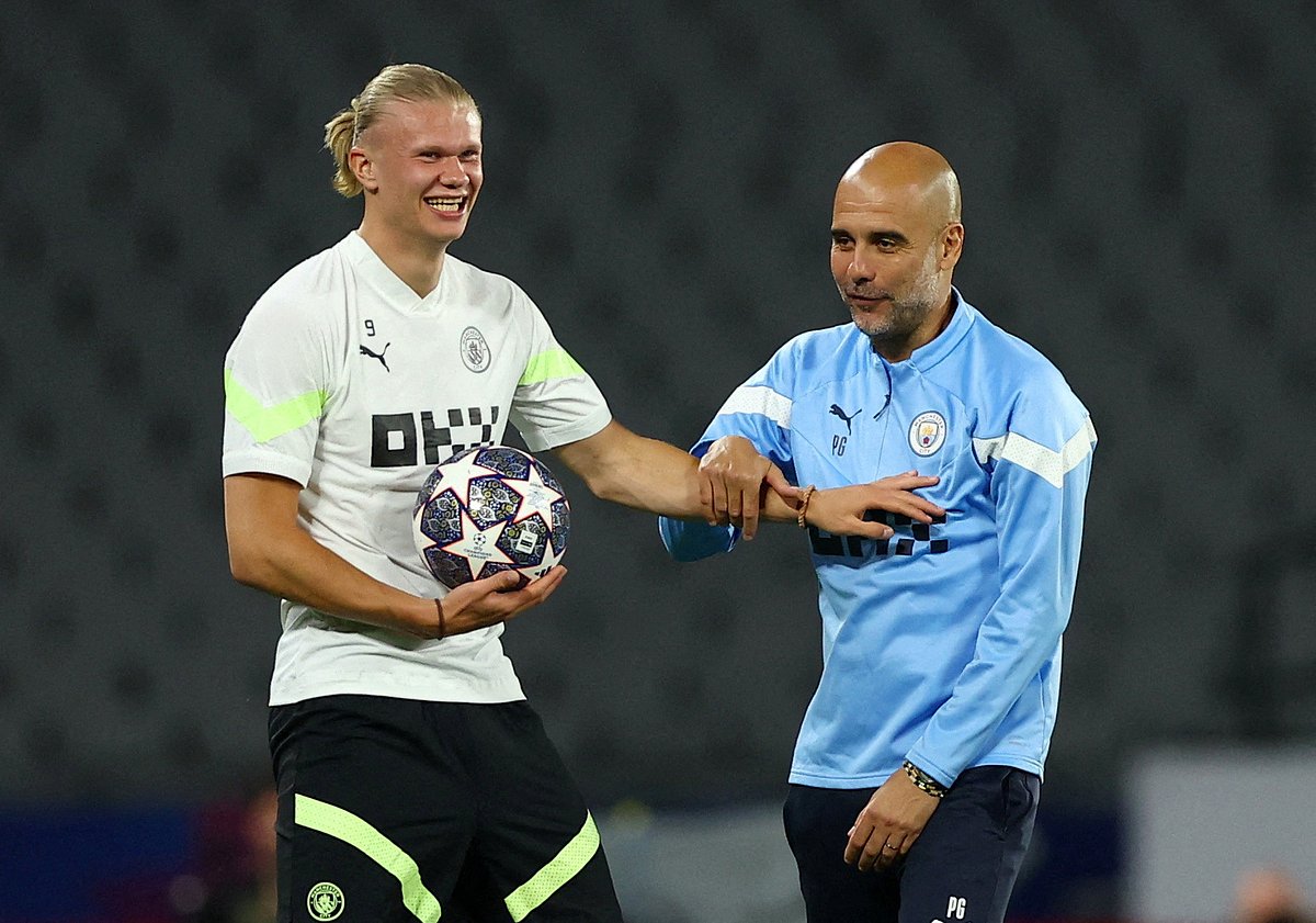 Manchester City manager Pep Guardiola with Erling Haaland during training