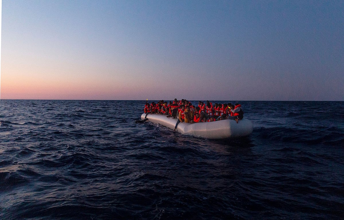 This handout picture taken and released on 23 July, 2022 by the NGO Sea-Watch shows a Sea-Watch 3 crew member on a lifeboat approaching an inflatable boat in distress with 120 people on board in the central Mediterranean. The number of migrant crossings through the central Mediterranean to the European Union "more than doubled" in 2023 compared to the same period last year, the EU's Frontex agency said on 16 June, 2023. In the first five months of this year, EU countries detected over 50,300 irregular entries through that route, "the highest number recorded since 2017," the agency said in a statement.