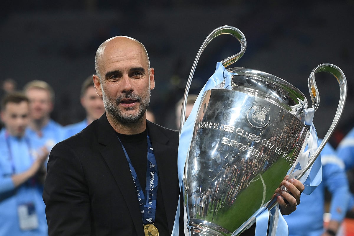 Manchester City's Spanish manager Pep Guardiola celebrates with the trophy after winning the UEFA Champions League final between Inter Milan and Manchester City at the Ataturk Olympic Stadium in Istanbul on 10 June 2023