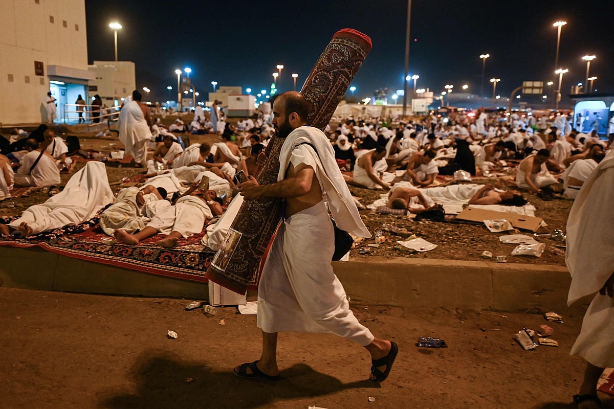 A Muslim pilgrim walks with a carpet after arriving at Muzdalifah before heading to Mina during the annual Muslim Hajj pilgrimage on 27 June 2023.