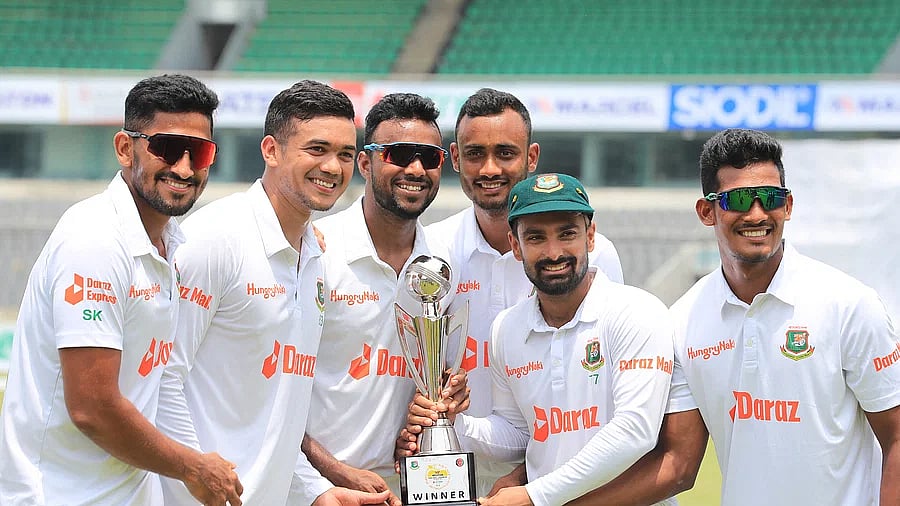 Bangladesh players celebrate with the trophy after defeating Afghanistan in the one-off Test