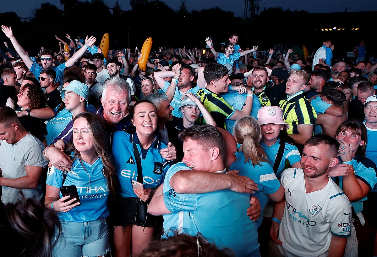 Manchester City fans celebrate at the Manchester's 4TheFans Fan Park in Manchester, Britain after their team won the Champions League final against Inter Milan in Istanbul  on 10 June 2023