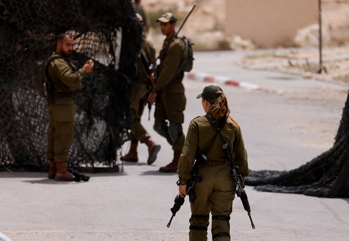 Soldiers walk near the site of a reported security incident near Israel's southern border with Egypt, Israel June 3, 2023.
