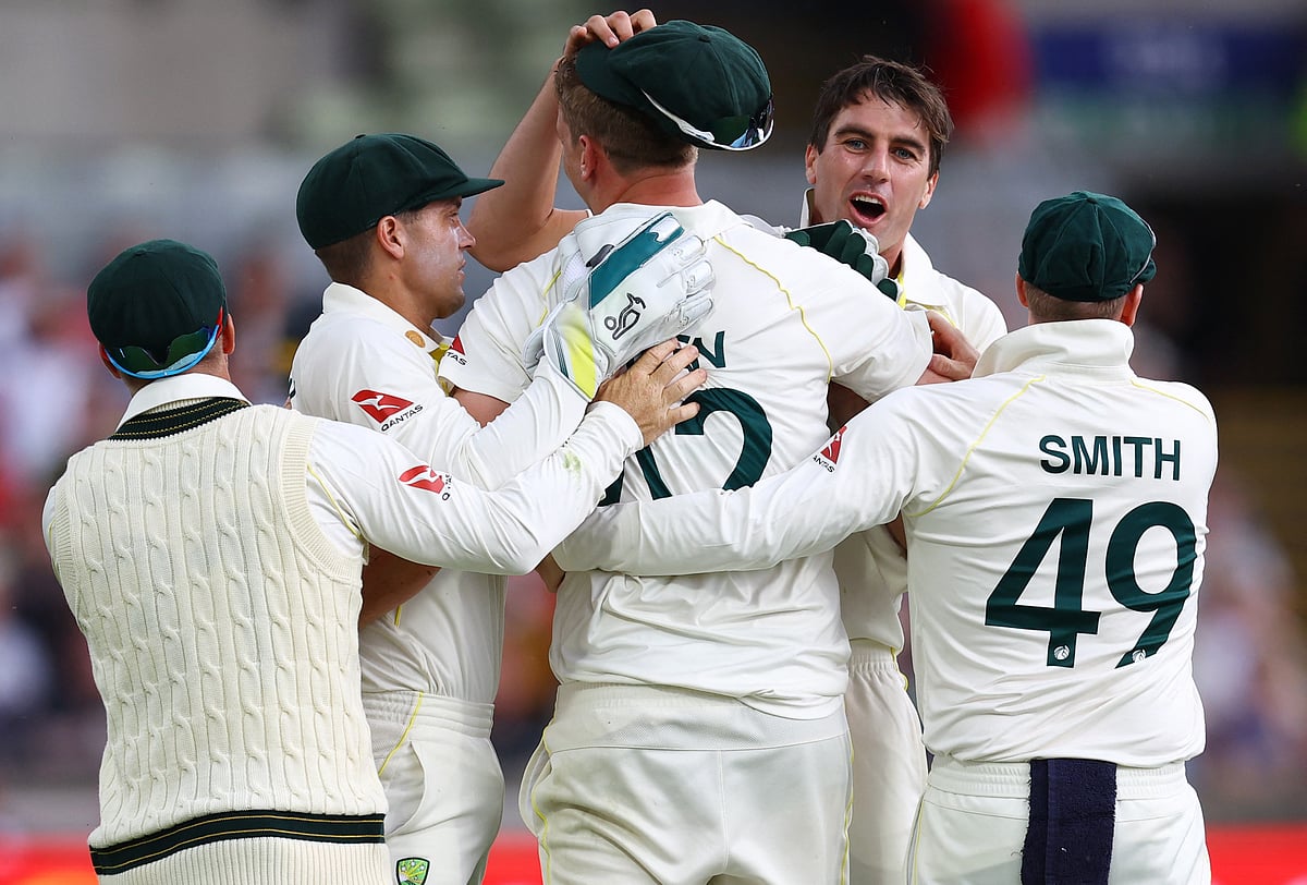Australia's Cameron Green celebrates with teammates after taking a catch to dismiss England's Ben Duckett off the bowling of Pat Cummins