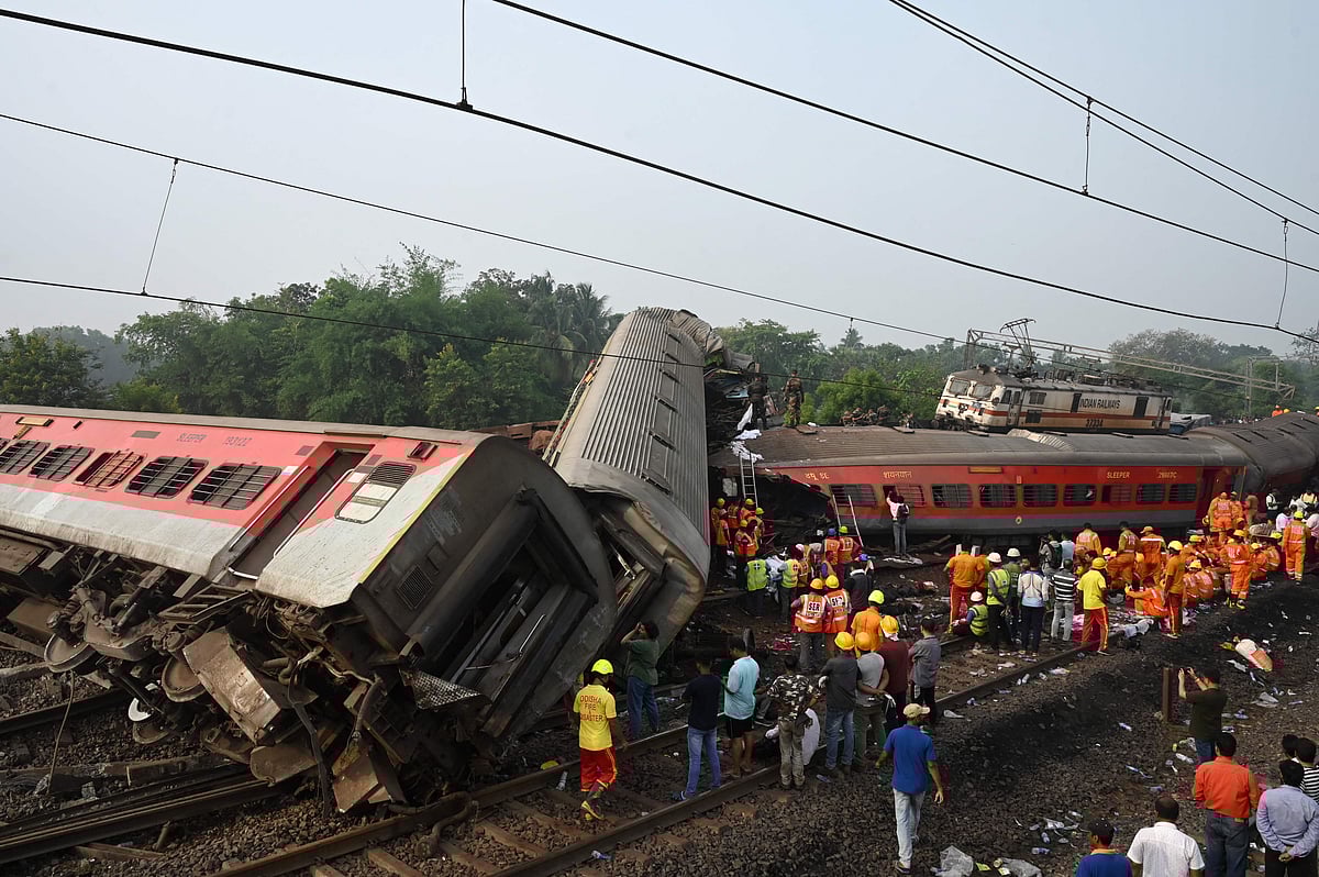 Rescue workers gather around damaged carriages during search for survivors at the accident site of a three-train collision near Balasore, about 200 km (125 miles) from the state capital Bhubaneswar in the eastern state of Odisha, on 3 June 2023. At least 288 people were killed and more than 850 injured in a horrific three-train collision in India, officials said on June 3, the country's deadliest rail accident in more than 20 years.