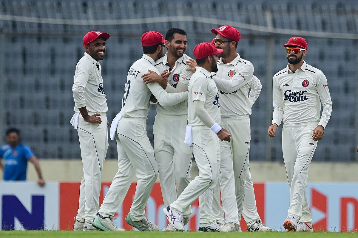 Afghanistan’s Nijat Masood (3L) celebrates with teammates after taking the wicket of Bangladesh’s Zakir Hasan (not pictured) during the first day of the Test cricket match between Bangladesh and Afghanistan at the Sher-e-Bangla National Cricket Stadium in Dhaka on 14 June, 2023