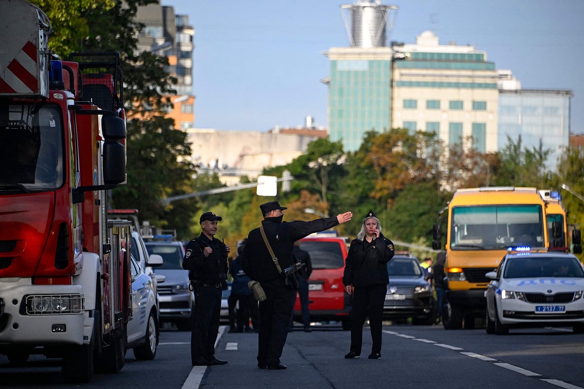 Police officers secure an area outside a damaged non-residential building on Komsomolsky Prospekt after a reported drone attack in Moscow on July 24, 2023