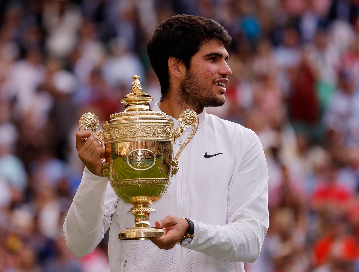 Spain's Carlos Alcaraz celebrates with the trophy after winning his final match against Serbia's Novak Djokovic
