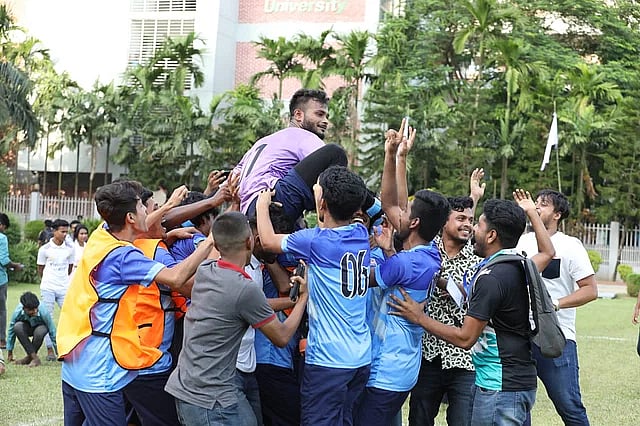 IUBAT players carry their goalkeeper Raza Foysal after he made the match-winning penalty save against IUB