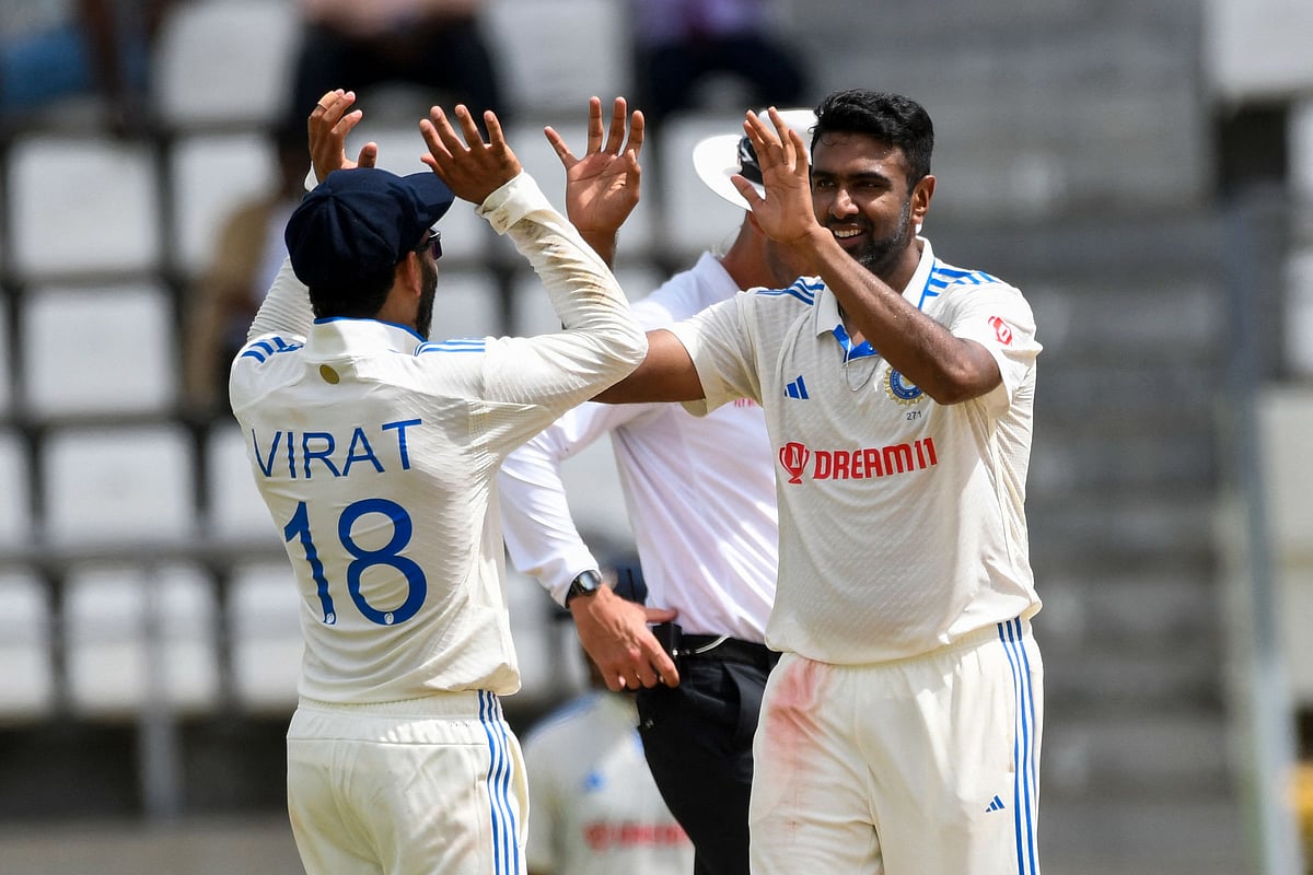 Ravichandran Ashwin (R) and Virat Kohli (L) of India celebrates the dismissal of Alzarri Joseph of West Indies during day one of the First Test between West Indies and India at Windsor Park in Roseau, Dominica, on 12 July, 2023