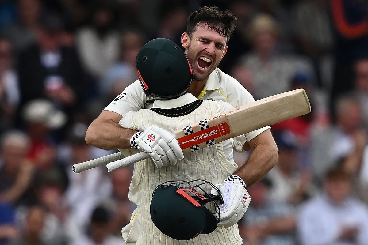 Australia's Mitchell Marsh celebrates with Australia's Travis Head (L) after reaching his hundred on day one of the third Ashes cricket Test match between England and Australia at Headingley cricket ground in Leeds, northern England on 6 July, 2023
