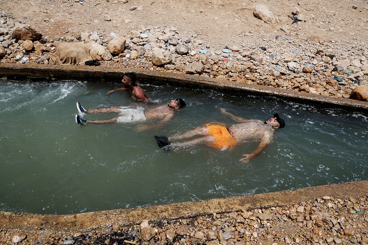 Palestinians cool off during a heat wave, in al-Oja springs near Jericho in the Israeli-occupied West Bank July 18, 2023