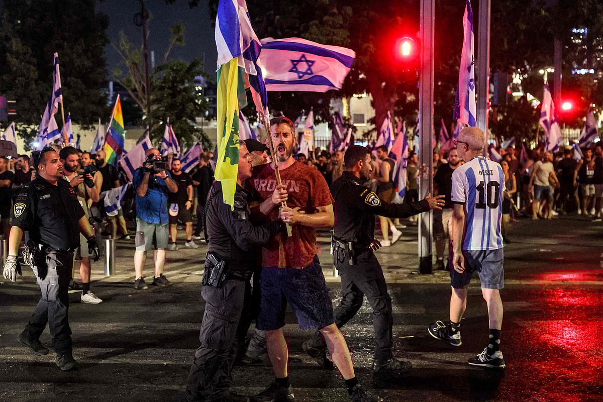 A demonstrator is restrained by an Israeli riot policeman during a protest rally against the Israeli government’s judicial reform plan in Tel Aviv on 24 July, 2023