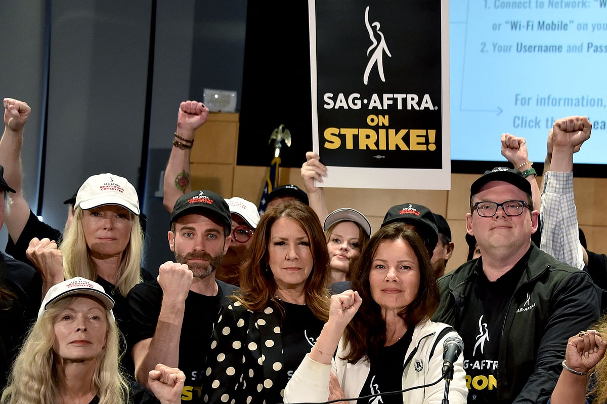 US actress Frances Fisher, SAG-AFTRA secretary-treasurer US actress Joely Fisher, SAG-AFTRA President US actress Fran Drescher, and National Executive Director and Chief Negotiator Duncan Crabtree-Ireland, joined by SAG-AFTRA members, pose for a photo during a press conference at the labor union's headquarters in Los Angeles, California, on 13 July, 2023.