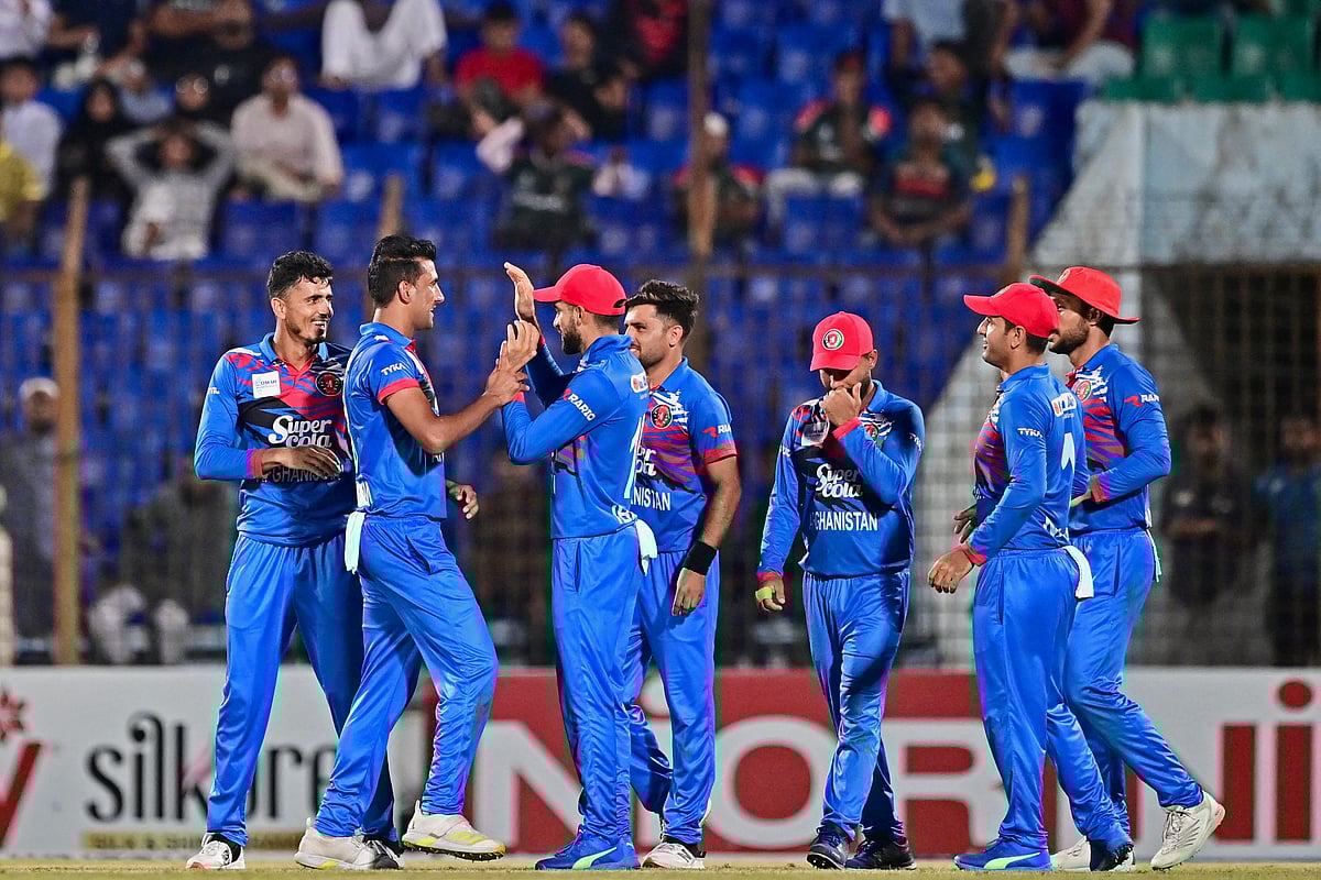 Afghanistan’s players celebrate after the dismissal of Bangladesh’s Mehidy Hasan Miraz (not pictured) during the second one-day international (ODI) cricket match between Bangladesh and Afghanistan at the Zahur Ahmed Chowdhury Stadium in Chittagong on 8 July, 2023