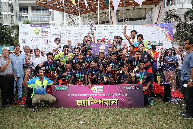 Gono Bishwabidyalay players celebrate with the trophy after defeating Fareast International University in the final of the Ispahani-Prothom Alo Inter University Football Tournament 2023 at Birulia, Savar on 30 July 2023