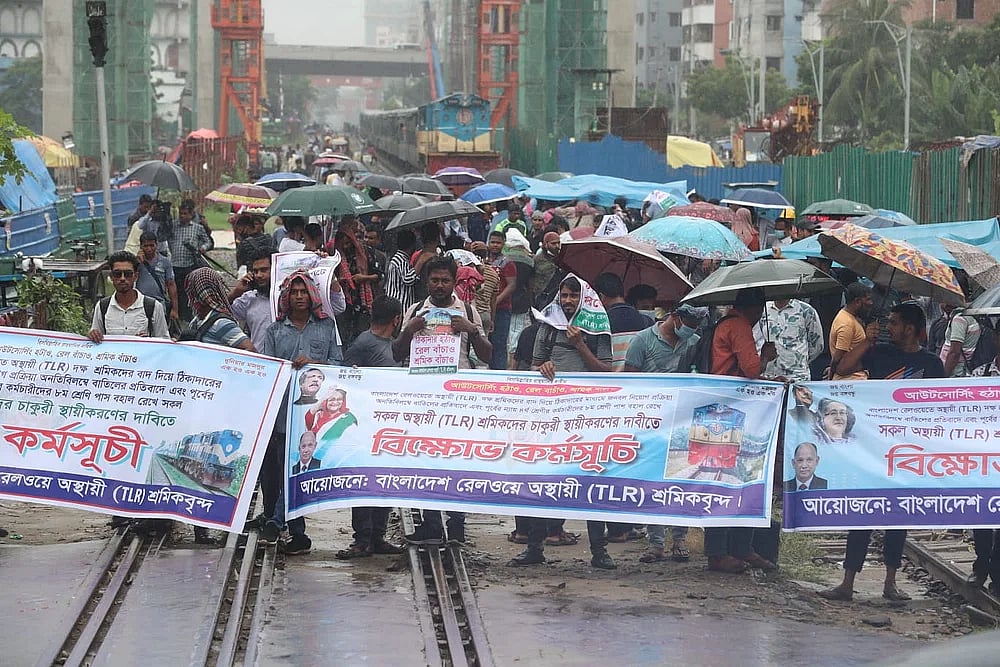 The railway workers took position on the rail-track in Dhaka