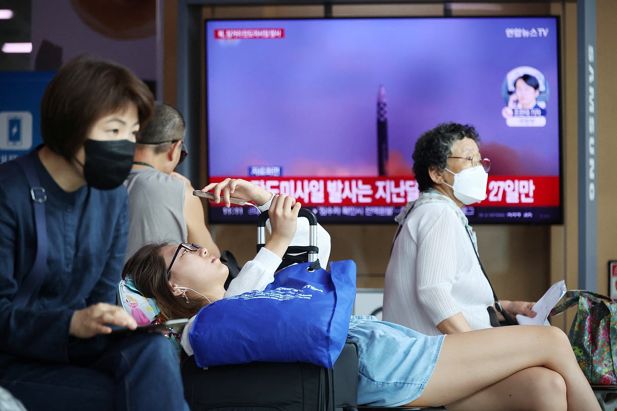 Passengers wait for their train in front of a TV broadcasting a news report on North Korea firing a ballistic missile off its east coast, at a railway station in Seoul, South Korea, July 12, 2023