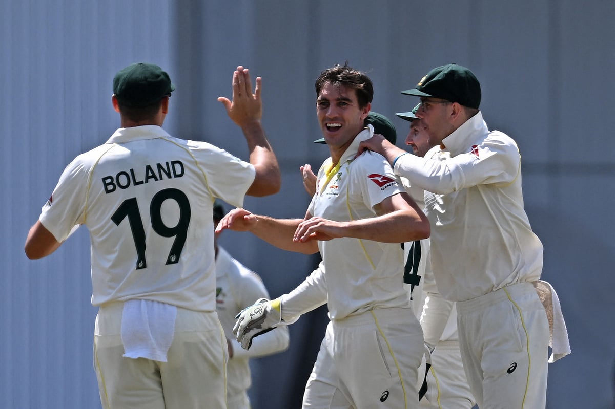 Australia's Pat Cummins (C) celebrates with teammates after taking the wicket of England's Moeen Ali on day two of the third Ashes cricket Test match between England and Australia at Headingley cricket ground in Leeds, northern England on 7 July, 2023