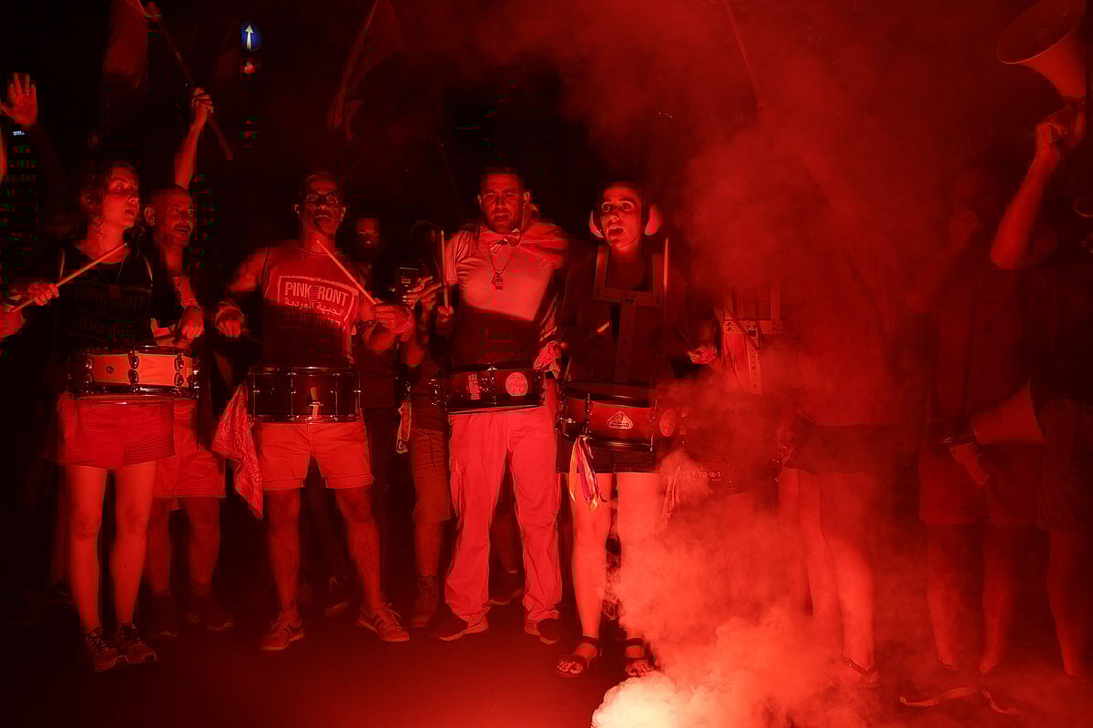 Protesters beat drums as they protest against the Israeli government's judicial overhaul plan in Tel Aviv on July 29, 2023.