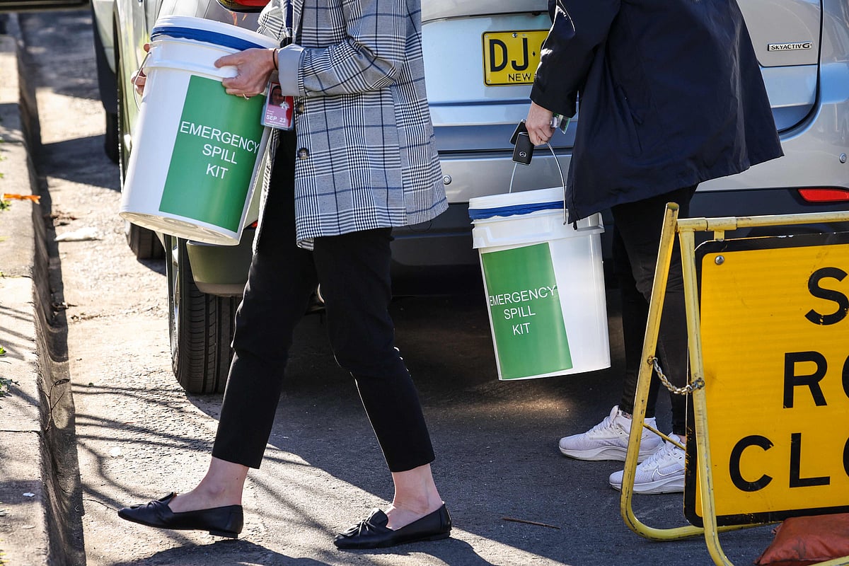 Australian Border Force agents gather equipment outside an apartment block after they raided it earlier amid media reports "nuclear isotopes" had been found, in Sydney on 17 August, 2023.