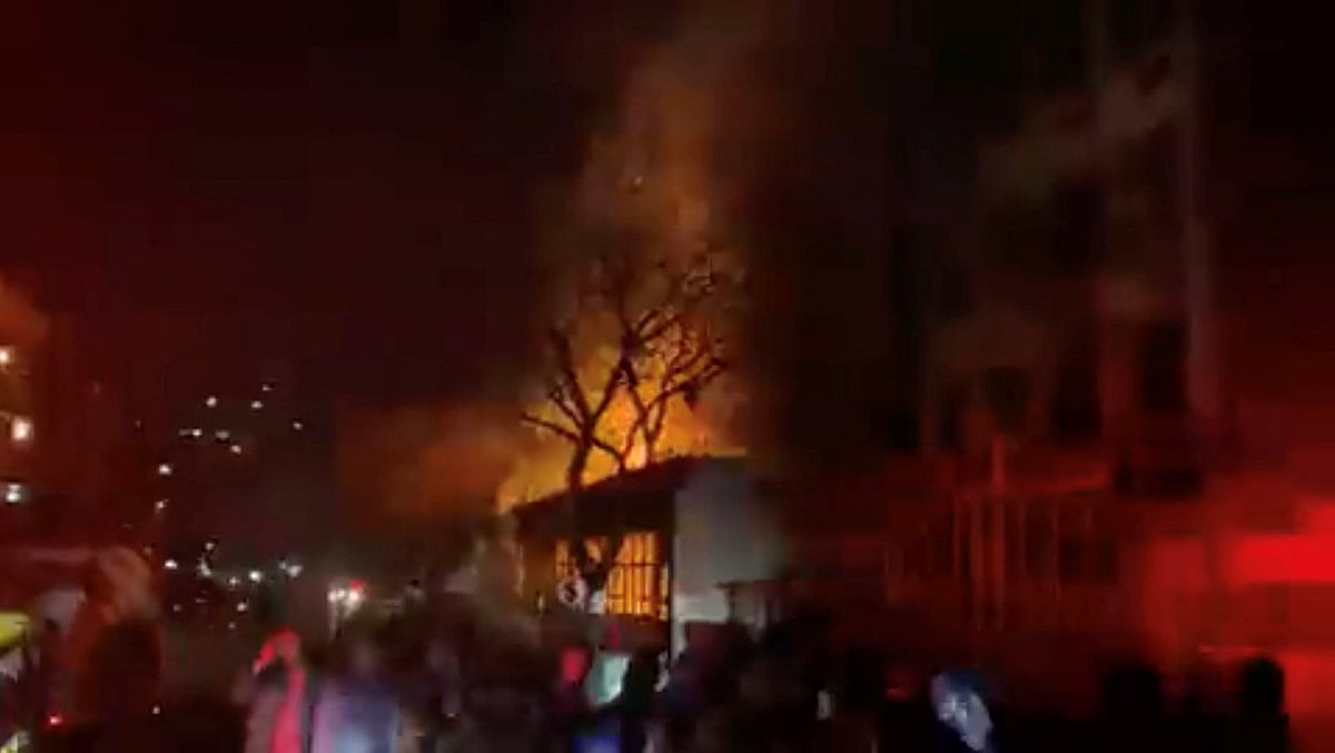 People gather near a building on fire in Johannesburg, South Africa on 31 August, 2023