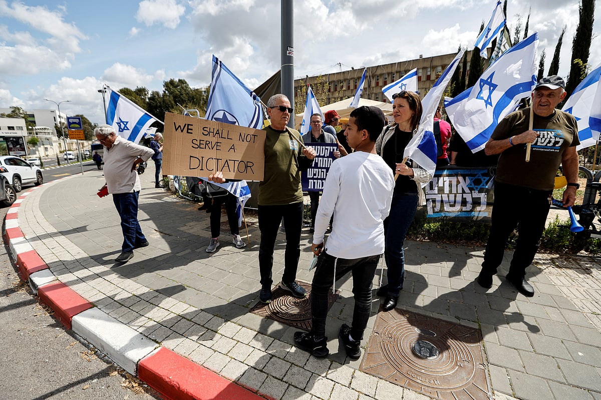 Members of the 'Brothers in Arms' reservist protest group demonstrate as Israeli Prime Minister Benjamin Netanyahu's nationalist coalition government pursues its judicial overhaul, outside a military base that absorbs and screens new recruits in Kiryat Ono, Israel, March 21, 2023.